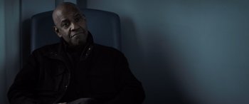 Movie still from “The Equalizer 3” (2023), directed by Antoine Fuqua – An older man sitting in a chair in a dark room; Close Up shot, Low angle