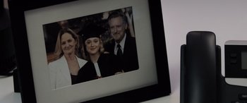 Movie still from “The Equalizer 3” (2023), directed by Antoine Fuqua – A picture of a family in a graduation cap and gown; Extreme Close Up shot, Overhead angle