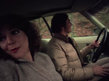 Movie still from “The Evil Dead” (1981), directed by Sam Raimi – A man and a woman in the back seat of a car; Medium shot, Low angle