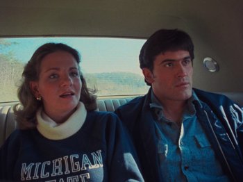 Movie still from “The Evil Dead” (1981), directed by Sam Raimi – A man and a woman sitting in the back of a car; Close Up shot, Over the shoulder angle