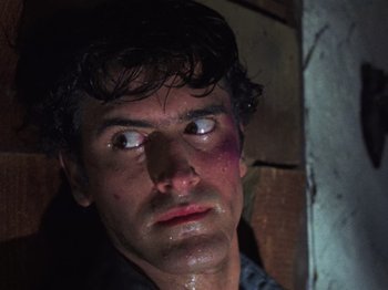 Movie still from “The Evil Dead” (1981), directed by Sam Raimi – A person with bruises on his face; Close Up shot, Low angle