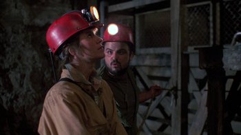 Movie still from “Day of the Dead” (1985), directed by George A. Romero – Two men wearing hard hats with lights on their heads; Medium shot, Low angle
