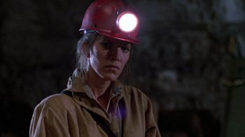 Movie still from “Day of the Dead” (1985), directed by George A. Romero – A woman wearing a red hard hat and a brown jacket; Close Up shot, Low angle