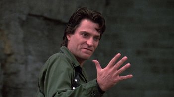 Movie still from “Day of the Dead” (1985), directed by George A. Romero – A person wearing a green shirt; Close Up shot, Low angle