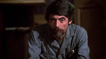 Movie still from “Day of the Dead” (1985), directed by George A. Romero – A person wearing a blue shirt; Close Up shot, Low angle