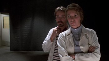 Movie still from “Day of the Dead” (1985), directed by George A. Romero – A man and a woman standing next to each other; Medium shot, Low angle