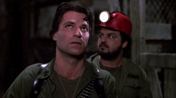 Movie still from “Day of the Dead” (1985), directed by George A. Romero – A man in a hard hat looking up at a man in a green shirt; Close Up shot, Low angle