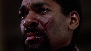 Movie still from “Day of the Dead” (1985), directed by George A. Romero – A person with blood on his face; Close Up shot, Low angle