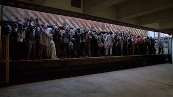 Movie still from “Day of the Dead” (1985), directed by George A. Romero – A group of people standing on top of a platform; Wide shot, High angle