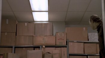 Movie still from “Day of the Dead” (1985), directed by George A. Romero – A room filled with lots of cardboard boxes on the floor; Wide shot, Low angle