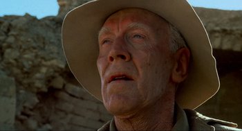 Movie still from “The Exorcist” (1973), directed by William Friedkin – An older man wearing a cowboy hat looking off into the distance; Close Up shot, Low angle