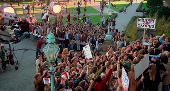 Movie still from “The Exorcist” (1973), directed by William Friedkin – A crowd of people gathered on a sidewalk; Extreme Wide shot, High angle