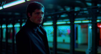 Movie still from “The Exorcist” (1973), directed by William Friedkin – A man standing in front of a train station; Medium shot, Low angle