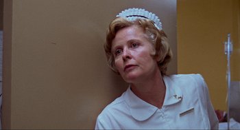 Movie still from “The Exorcist” (1973), directed by William Friedkin – An older woman wearing a nurse's uniform; Close Up shot, Low angle