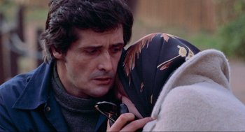 Movie still from “The Exorcist” (1973), directed by William Friedkin – A person holding an umbrella; Close Up shot, Over the shoulder angle