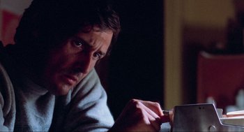 Movie still from “The Exorcist” (1973), directed by William Friedkin – A person holding something in his hand; Close Up shot, Over the shoulder angle