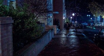 Movie still from “The Exorcist” (1973), directed by William Friedkin – A person walking down a street at night; Extreme Wide shot, High angle