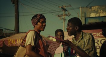 Movie still from “The Exorcist: Believer” (2023), directed by David Gordon Green – Two men talking to each other while one of them is holding a toothbrush; Medium shot, Over the shoulder angle