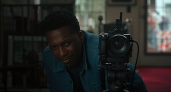 Movie still from “The Exorcist: Believer” (2023), directed by David Gordon Green – A man is taking a picture with a camera; Close Up shot, Over the shoulder angle
