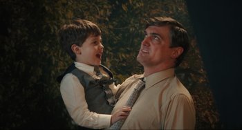 Movie still from “The Exorcist: Believer” (2023), directed by David Gordon Green – A man and a boy in dress clothes and ties; Medium shot, Over the shoulder angle