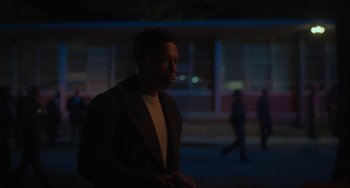 Movie still from “The Exorcist: Believer” (2023), directed by David Gordon Green – A man standing in the dark in front of a building; Medium shot, Over the shoulder angle