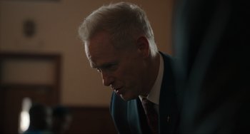 Movie still from “The Exorcist: Believer” (2023), directed by David Gordon Green – A person wearing a suit and tie; Close Up shot, Over the shoulder angle