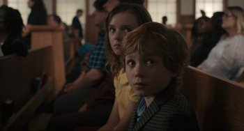 Movie still from “The Exorcist: Believer” (2023), directed by David Gordon Green – A boy and a girl are sitting in a room; Close Up shot, Over the shoulder angle