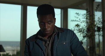 Movie still from “The Exorcist: Believer” (2023), directed by David Gordon Green – A man in a blue jacket is looking at the camera; Close Up shot, Low angle