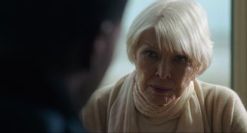 Movie still from “The Exorcist: Believer” (2023), directed by David Gordon Green – An older woman with white hair looking at the camera; Close Up shot, Over the shoulder angle