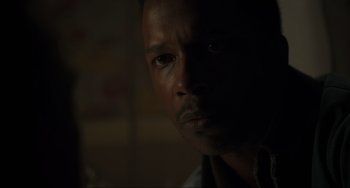 Movie still from “The Exorcist: Believer” (2023), directed by David Gordon Green – A man's face in the dark; Close Up shot, Over the shoulder angle