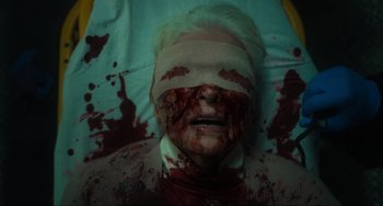 Movie still from “The Exorcist: Believer” (2023), directed by David Gordon Green – A man with blood all over his face and head; Close Up shot, Overhead angle