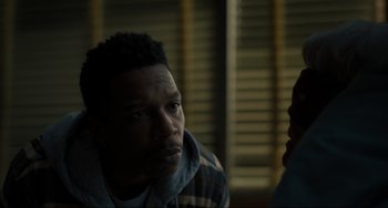 Movie still from “The Exorcist: Believer” (2023), directed by David Gordon Green – A man in a hooded jacket is looking at the camera; Close Up shot, Over the shoulder angle