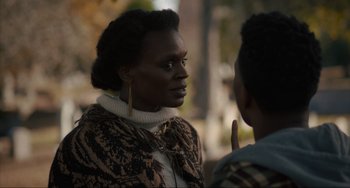 Movie still from “The Exorcist: Believer” (2023), directed by David Gordon Green – A woman in a brown jacket talking to a man in a brown jacket; Close Up shot, Over the shoulder angle