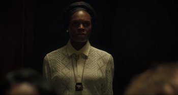 Movie still from “The Exorcist: Believer” (2023), directed by David Gordon Green – A woman in a white shirt and a black head scarf; Close Up shot, Over the shoulder angle