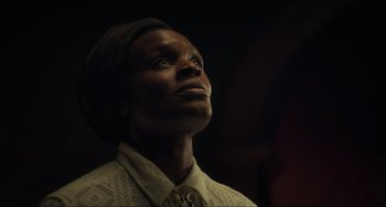 Movie still from “The Exorcist: Believer” (2023), directed by David Gordon Green – A man in a white shirt and tie looking up; Close Up shot, Low angle