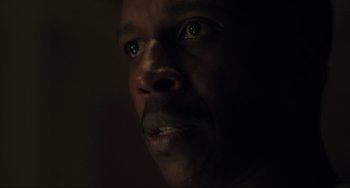 Movie still from “The Exorcist: Believer” (2023), directed by David Gordon Green – A man's face in the dark; Close Up shot, Low angle