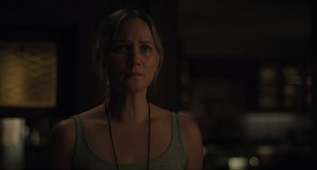 Movie still from “The Exorcist: Believer” (2023), directed by David Gordon Green – A woman in a gray tank top is looking at the camera; Close Up shot, Over the shoulder angle