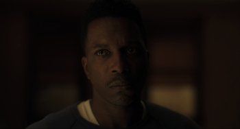 Movie still from “The Exorcist: Believer” (2023), directed by David Gordon Green – A person's face in the dark; Close Up shot, Low angle