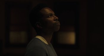 Movie still from “The Exorcist: Believer” (2023), directed by David Gordon Green – A man looking up into the sky in the dark; Close Up shot, Low angle