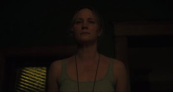 Movie still from “The Exorcist: Believer” (2023), directed by David Gordon Green – A woman is standing in a dark room; Close Up shot, Low angle