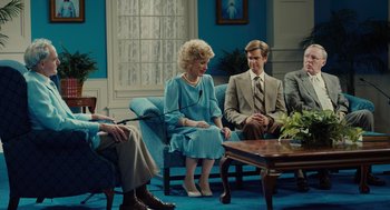 A group of people sitting around a living room