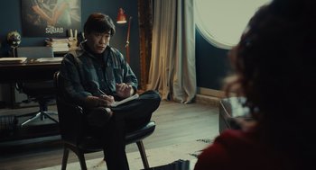 A man sitting in a chair in front of a woman