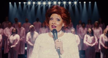 A woman in a white dress is holding a microphone