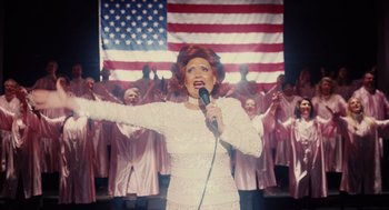 A woman in a white dress singing into a microphone