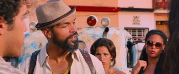 Movie still from “The Fate of the Furious” (2017), directed by F. Gary Gray – A man and a woman standing next to each other in front of an old truck; Close Up shot, Over the shoulder angle