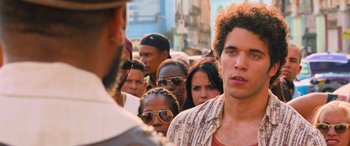 Movie still from “The Fate of the Furious” (2017), directed by F. Gary Gray – A group of people standing in a crowd; Close Up shot, Over the shoulder angle