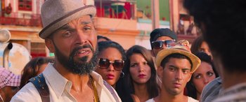 Movie still from “The Fate of the Furious” (2017), directed by F. Gary Gray – A group of men and women standing next to each other; Close Up shot, Over the shoulder angle