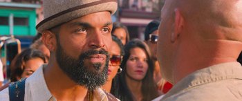Movie still from “The Fate of the Furious” (2017), directed by F. Gary Gray – A group of people standing in a crowd of people; Close Up shot, Over the shoulder angle
