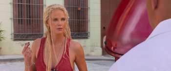 Movie still from “The Fate of the Furious” (2017), directed by F. Gary Gray – A woman with blonde dreadlocks standing next to a red fire truck; Close Up shot, Over the shoulder angle