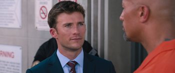 Movie still from “The Fate of the Furious” (2017), directed by F. Gary Gray – A man in a suit and a tie; Close Up shot, Over the shoulder angle